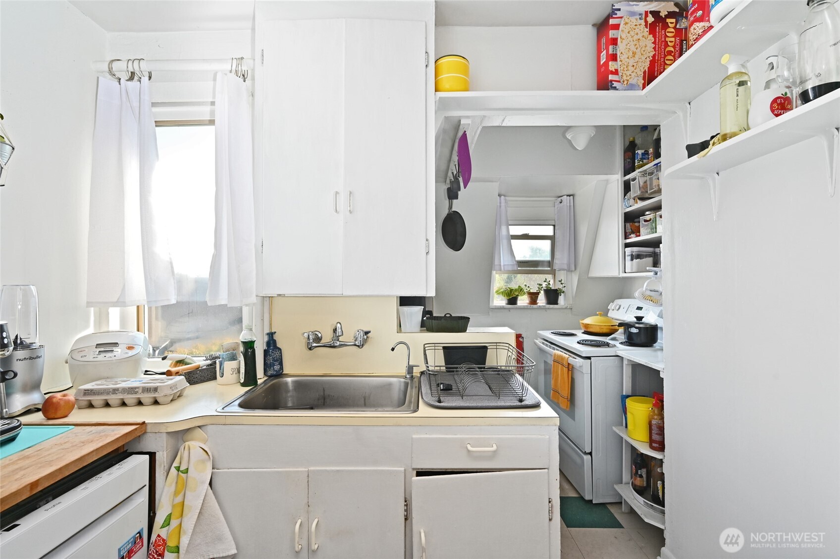 1425 East Prospect Street, Unit 110 Seattle, WA 98112 - Photo 33 of 40 a kitchen with a sink a stove and a refrigerator