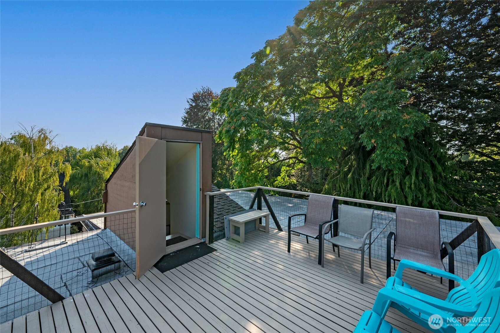 1425 East Prospect Street, Unit 110 Seattle, WA 98112 - Photo 7 of 40 a roof deck with table and chairs and wooden floor