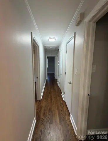 a view of hallway with wooden floor