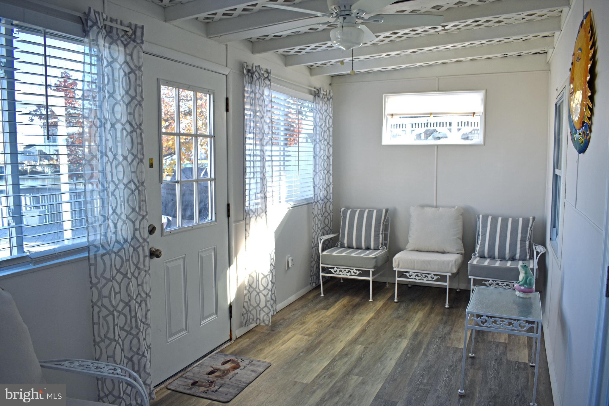 1029 Radio Road Little Egg Harbor, NJ 08087 - Photo 12 of 25 a living room with furniture and a floor to ceiling window