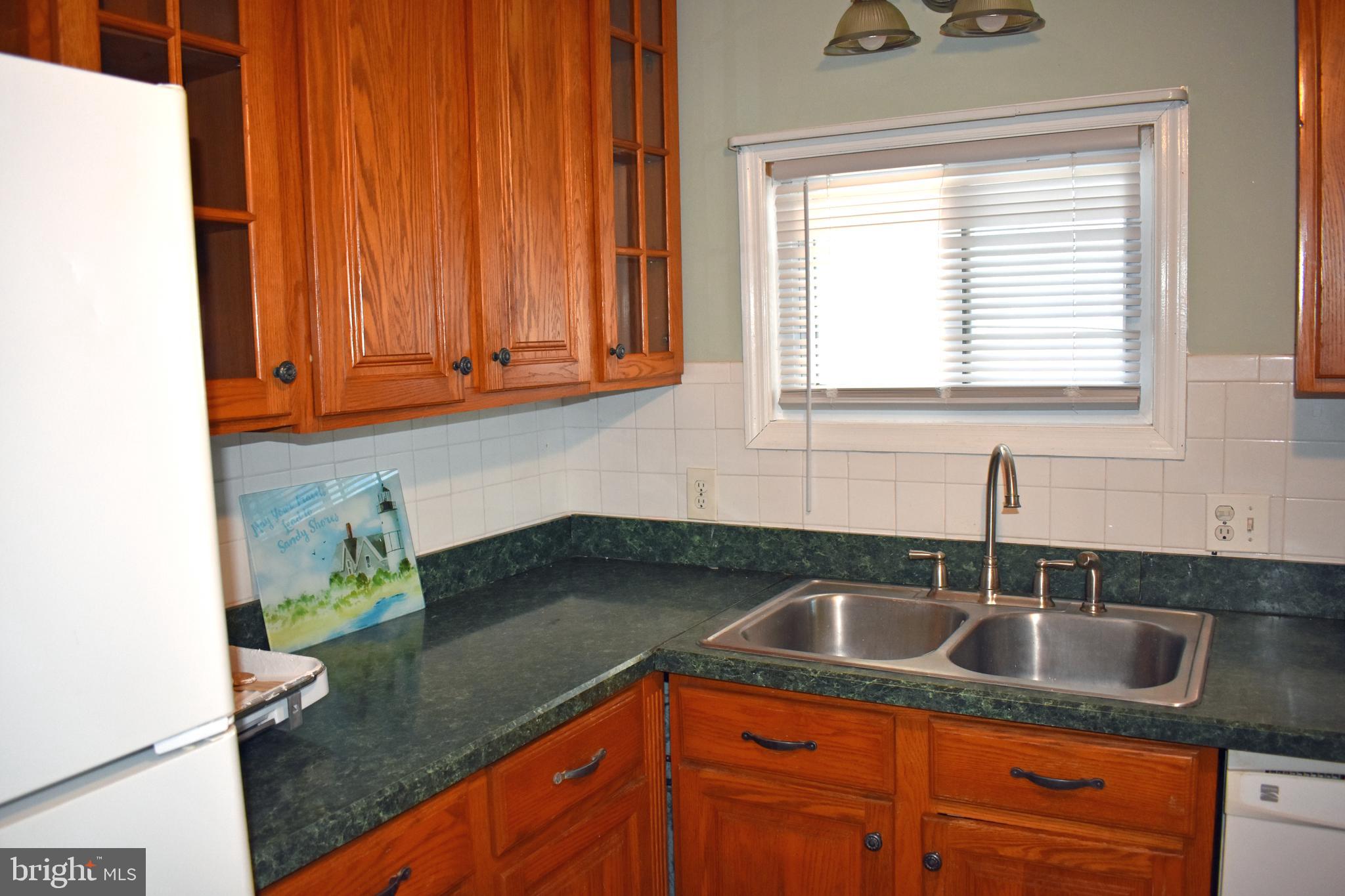 1029 Radio Road Little Egg Harbor, NJ 08087 - Photo 14 of 25 a kitchen with a sink a cabinets and window