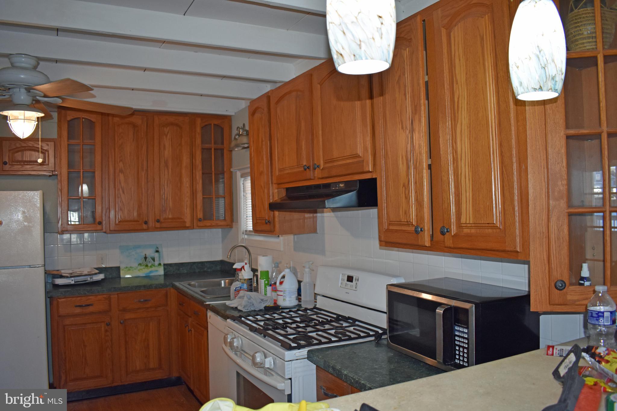 1029 Radio Road Little Egg Harbor, NJ 08087 - Photo 18 of 25 a kitchen with granite countertop a stove and a wooden cabinets