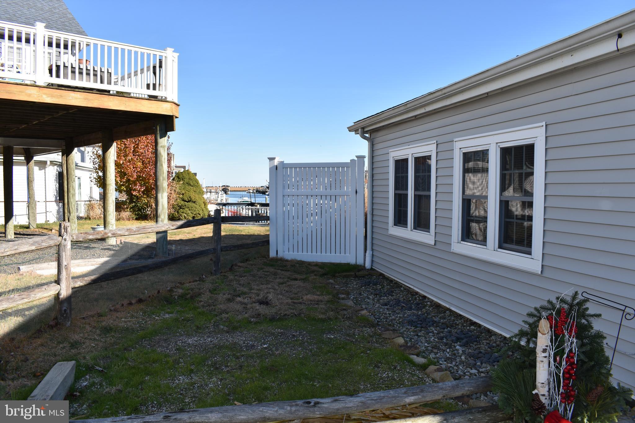 1029 Radio Road Little Egg Harbor, NJ 08087 - Photo 19 of 25 a backyard of a house with barbeque oven table and chairs