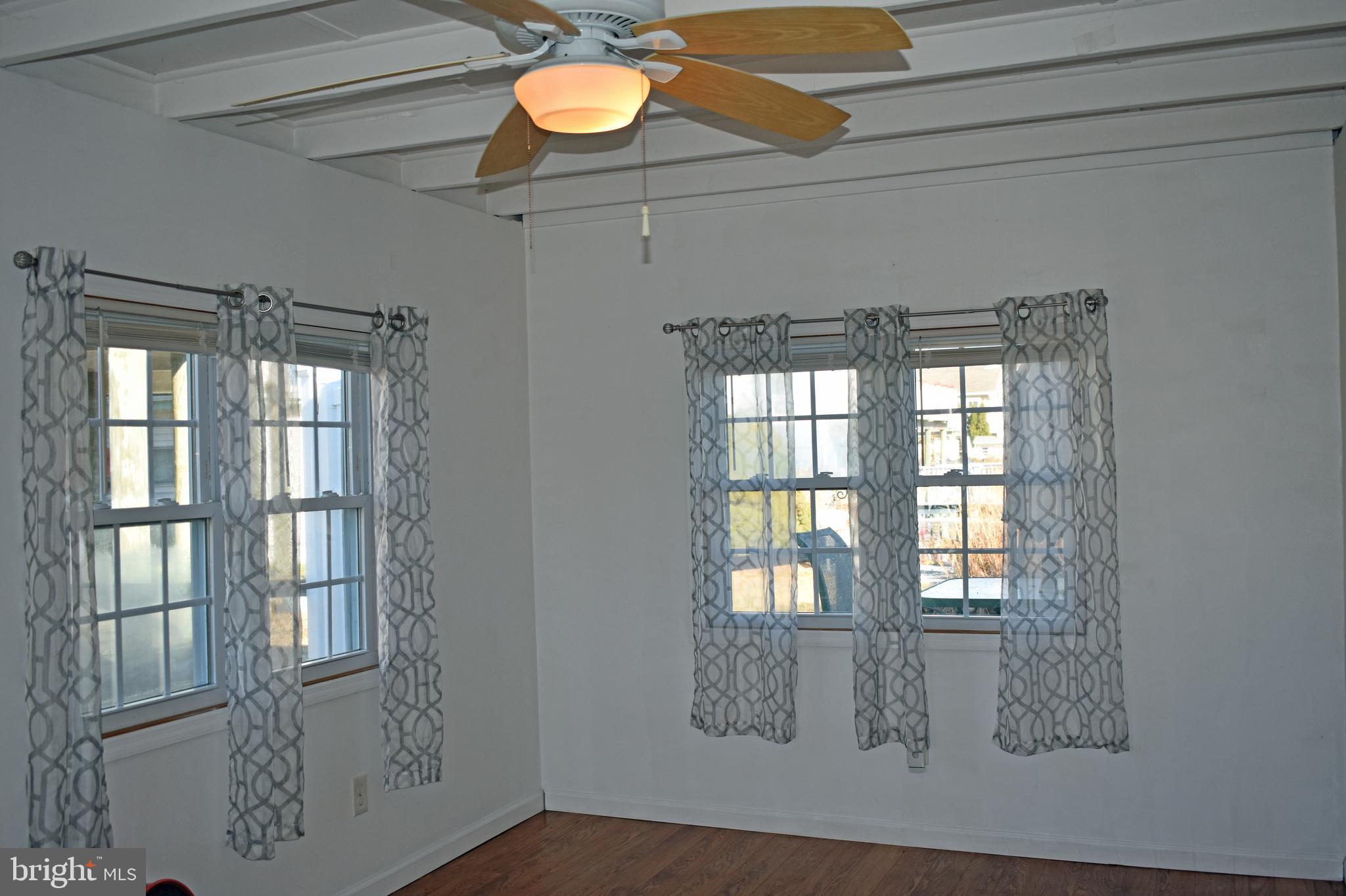 1029 Radio Road Little Egg Harbor, NJ 08087 - Photo 3 of 25 a view of wooden floor and windows in a room
