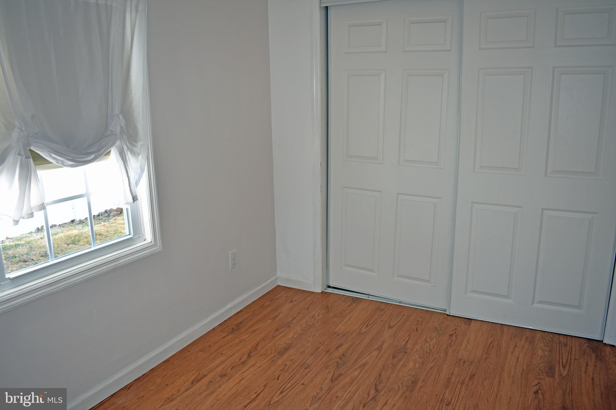1029 Radio Road Little Egg Harbor, NJ 08087 - Photo 9 of 25 an empty room with wooden floor and windows