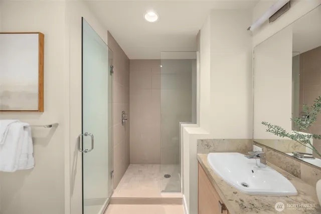 a bathroom with a sink and mirror with toilet