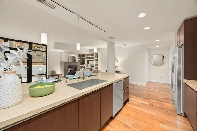 a kitchen with sink and refrigerator