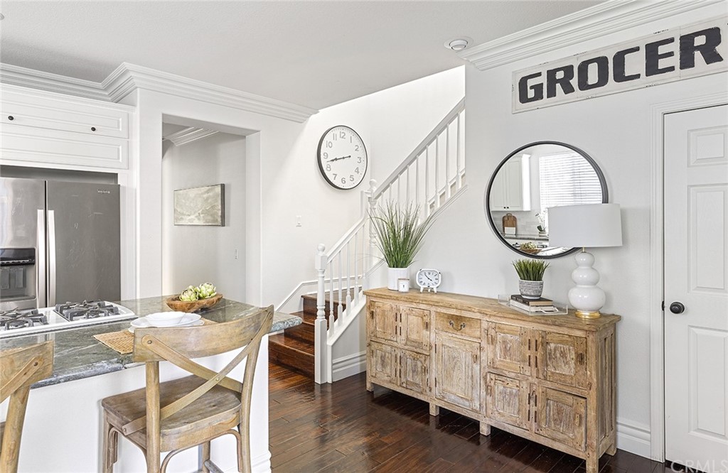 22 Alcott Street Ladera Ranch, CA 92694 - Photo 15 of 46 a dining room with furniture a kitchen view and a mirror