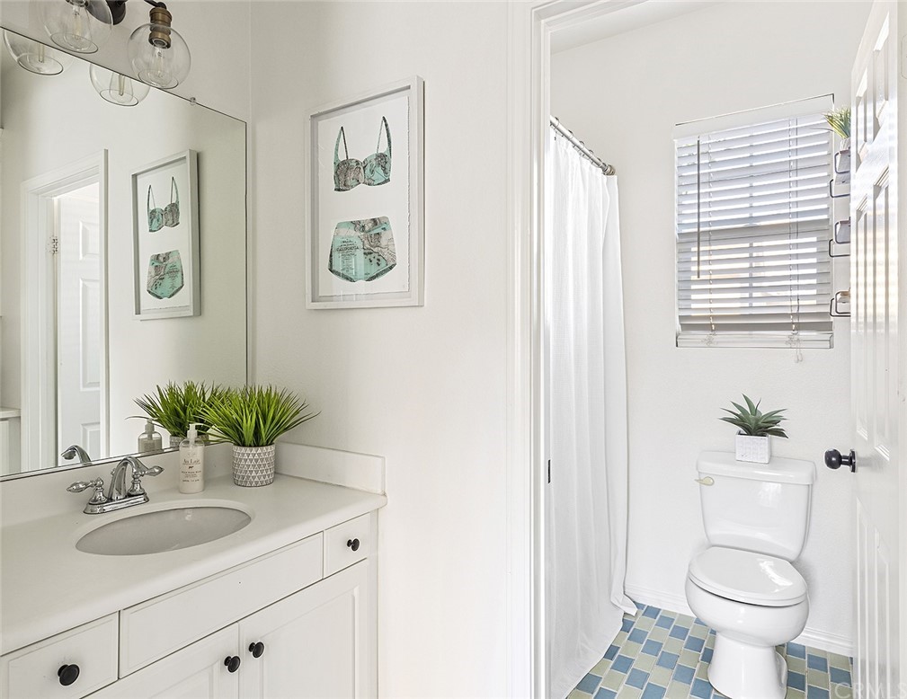 22 Alcott Street Ladera Ranch, CA 92694 - Photo 31 of 46 a bathroom with a granite countertop sink and a mirror