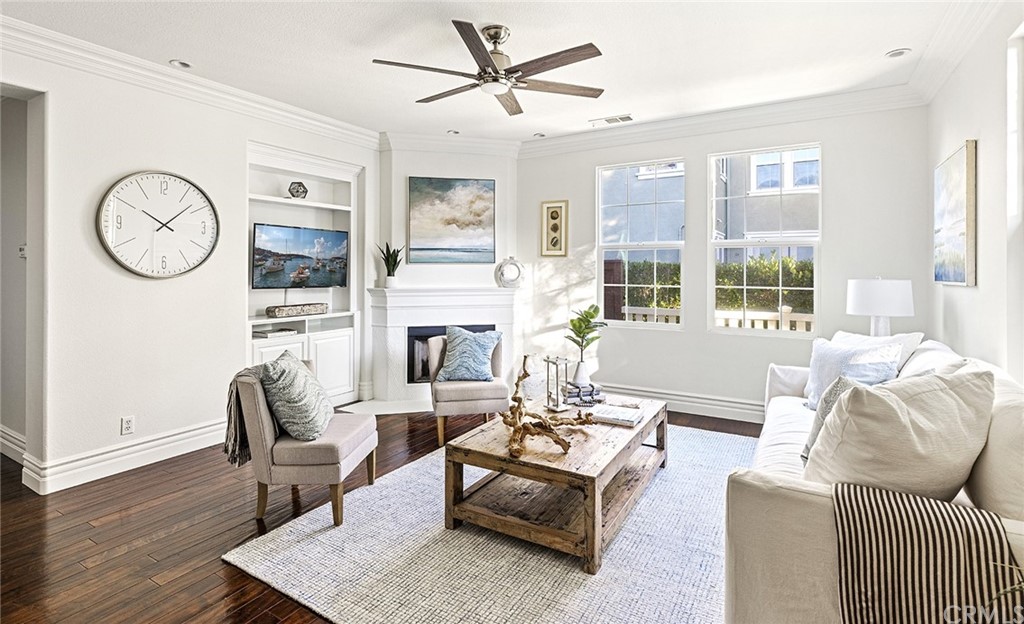 22 Alcott Street Ladera Ranch, CA 92694 - Photo 6 of 46 a living room with furniture a fireplace and a large window
