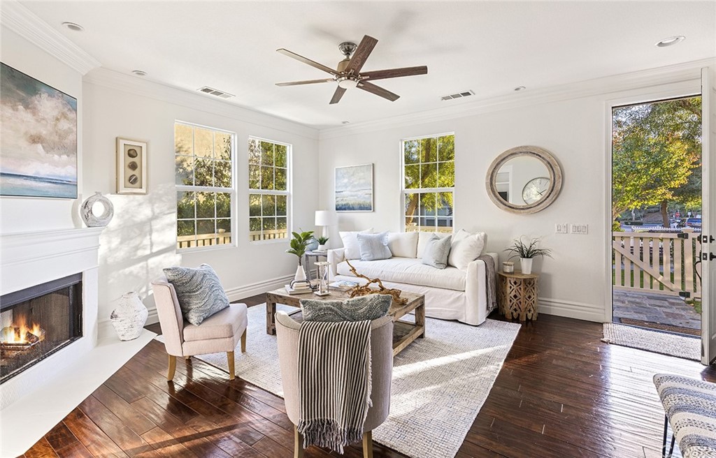 22 Alcott Street Ladera Ranch, CA 92694 - Photo 7 of 46 a living room with furniture a fireplace and a large window