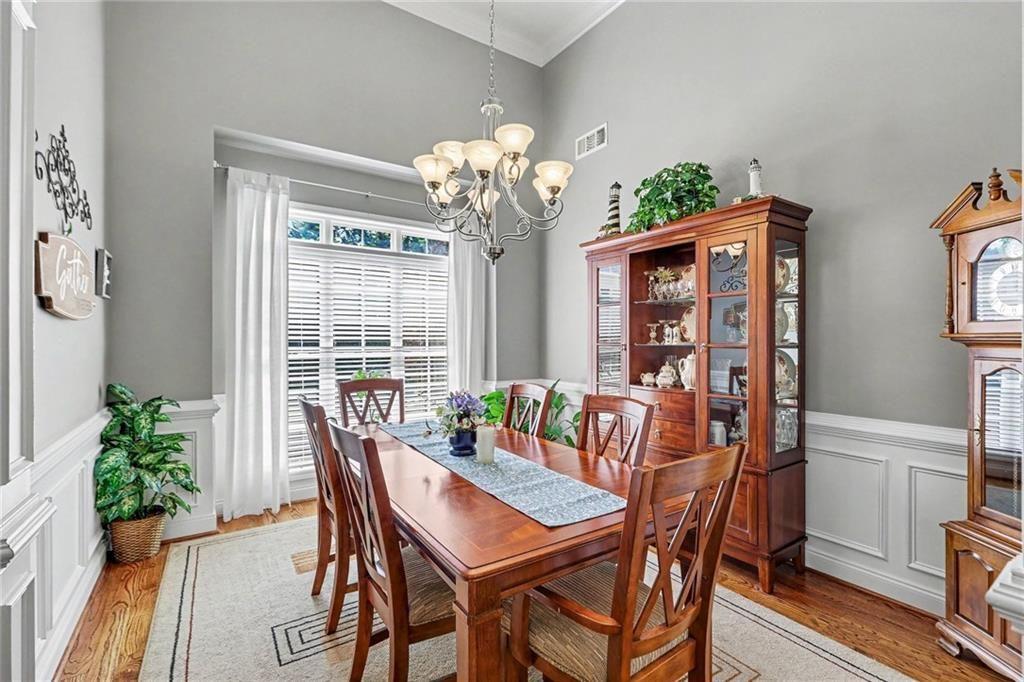 3792 Falls Trail Winston, GA 30187 - Photo 6 of 33 a dining room with furniture potted plants and wooden floor