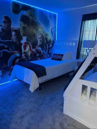 a bedroom with a bed and lamp