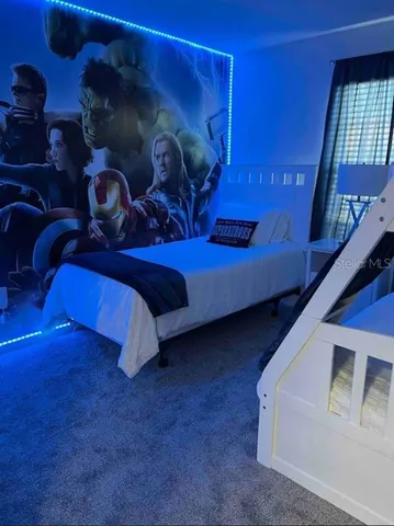 a bedroom with a bed and lamp