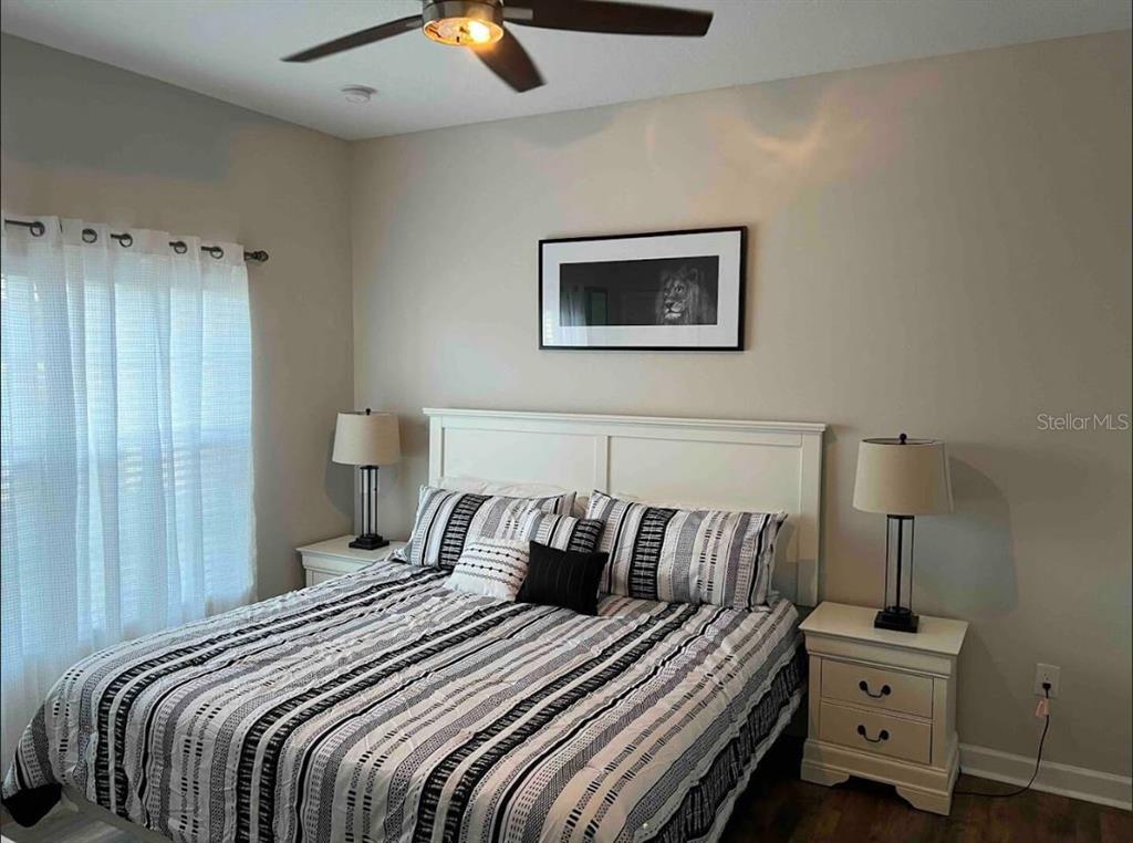 8947 Candy Palm Road Kissimmee, FL 34747 - Photo 13 of 16 a bedroom with a bed and lamp