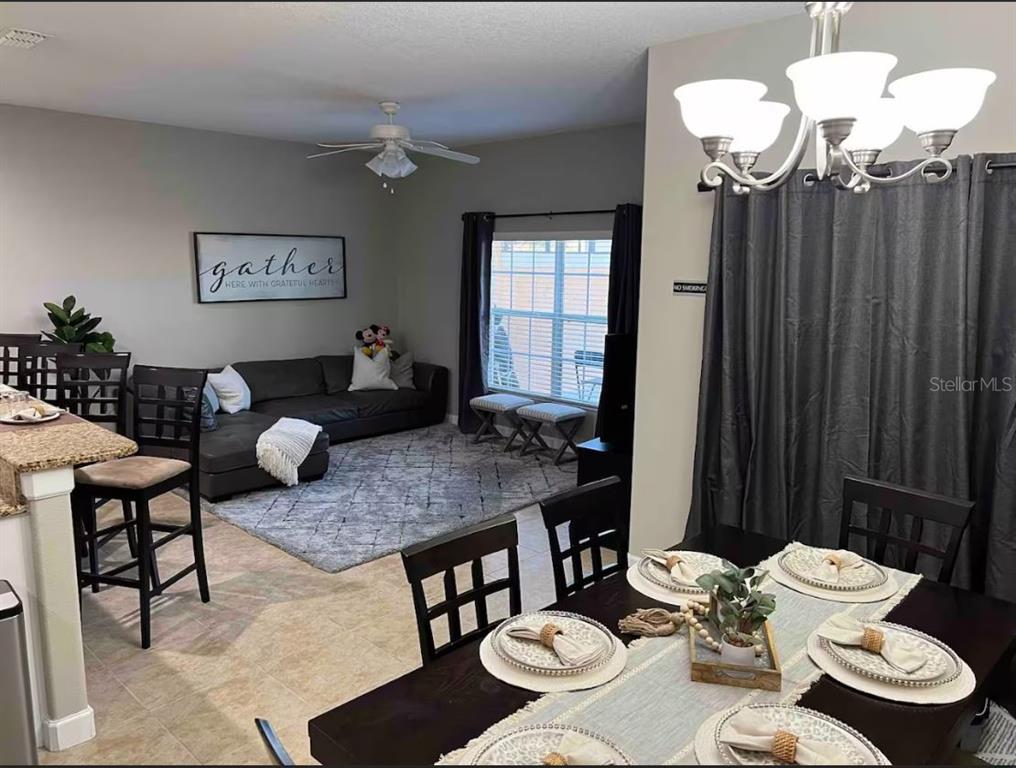 8947 Candy Palm Road Kissimmee, FL 34747 - Photo 4 of 16 a living room with furniture and a table