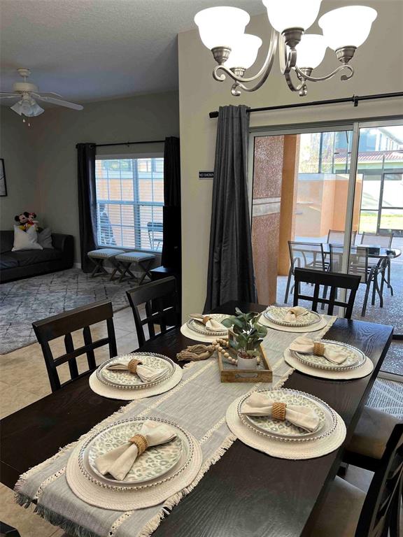 8947 Candy Palm Road Kissimmee, FL 34747 - Photo 8 of 16 a dining room with furniture a large window and wooden floor