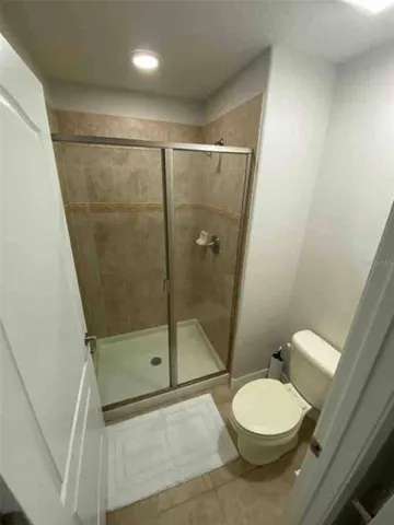 a bathroom with a toilet and a shower