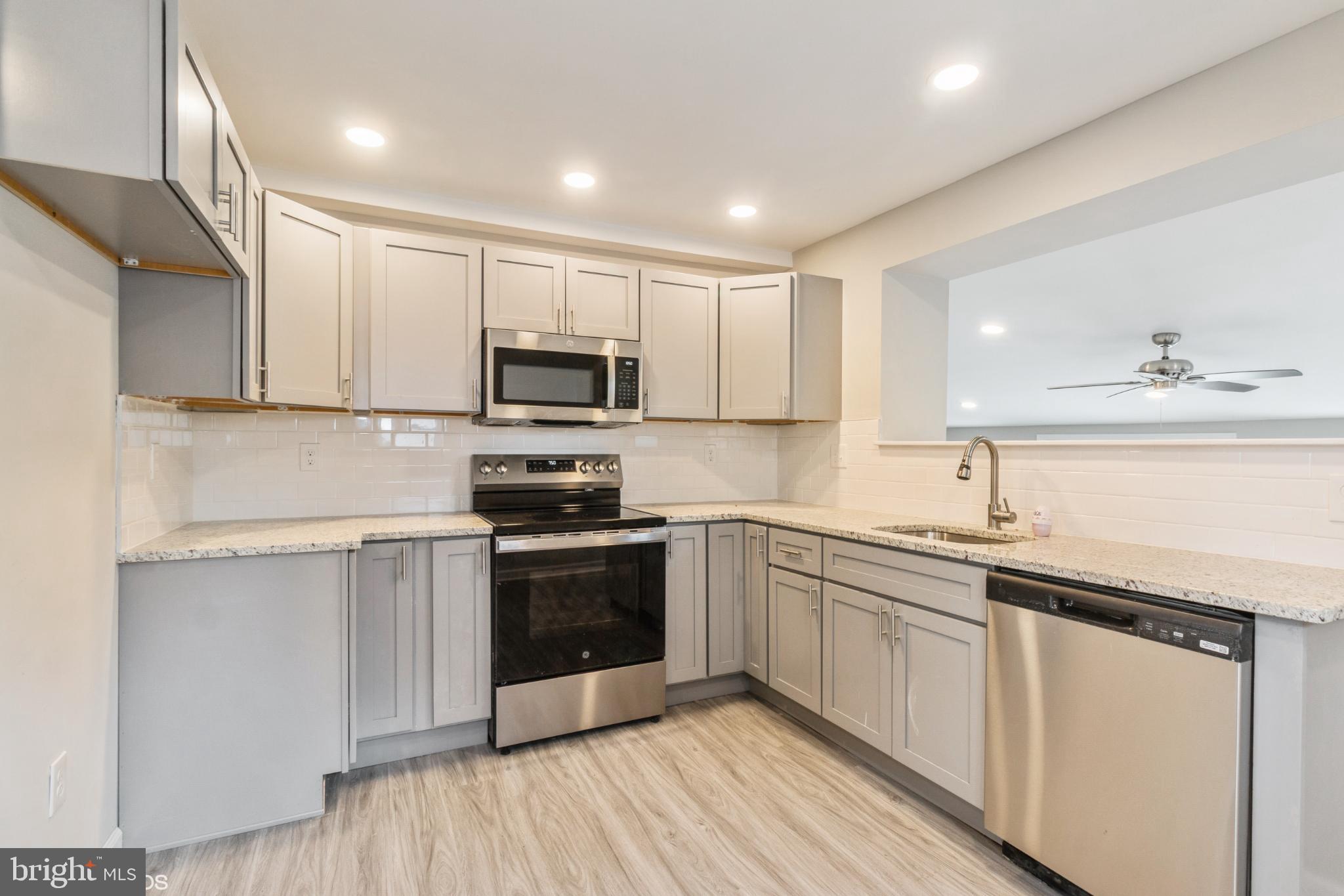 425 Grape Street Warminster, PA 18974 - Photo 7 of 26 a kitchen with sink a microwave and cabinets