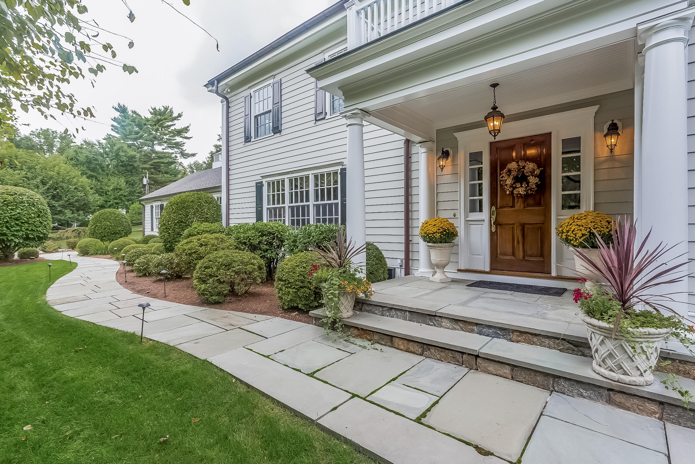 6 Watch Tower Road Darien, CT 06820 - Photo 1 of 30 a front view of a house with outdoor seating