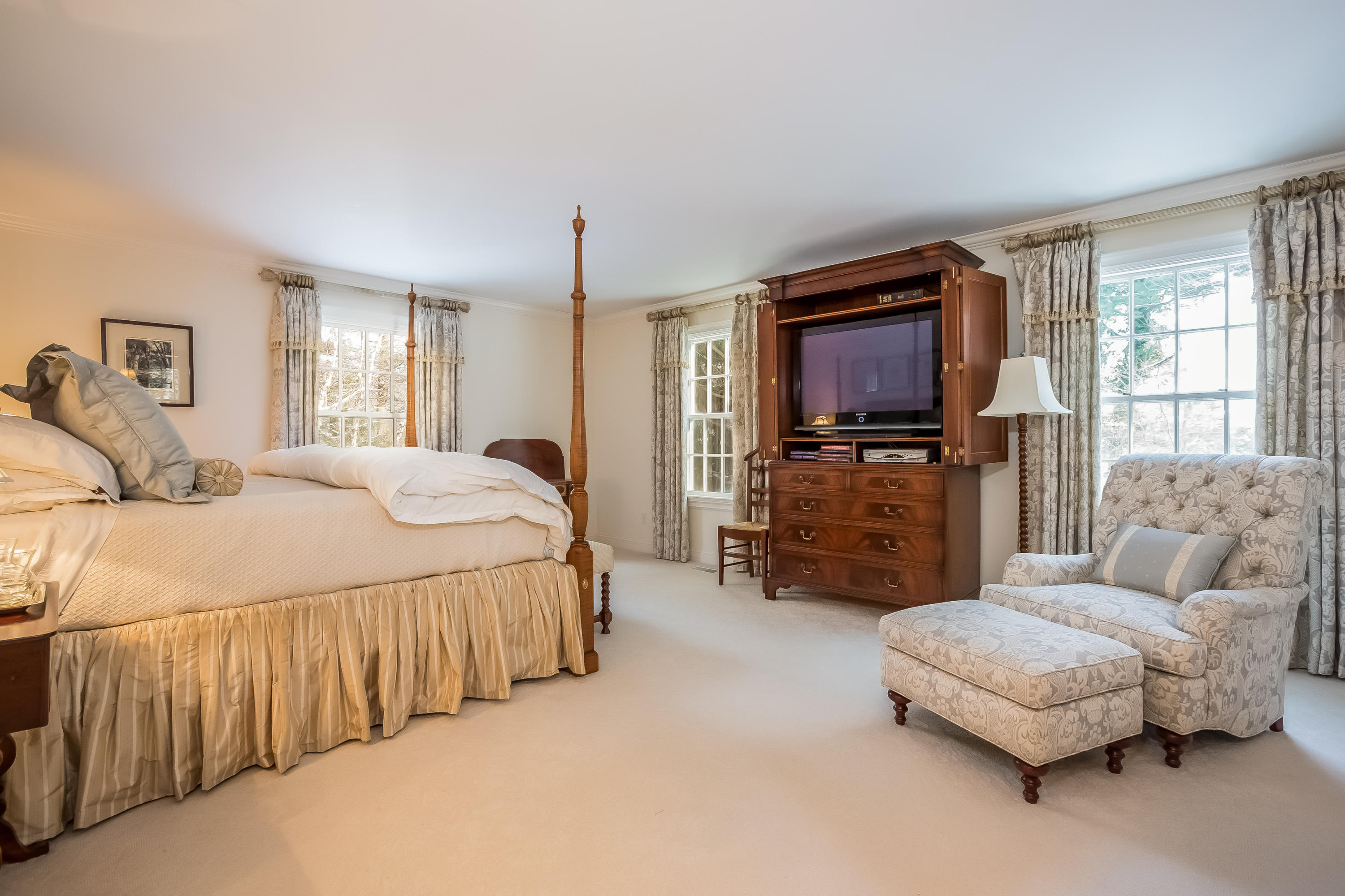6 Watch Tower Road Darien, CT 06820 - Photo 12 of 30 a spacious bedroom with a bed a couch and dresser