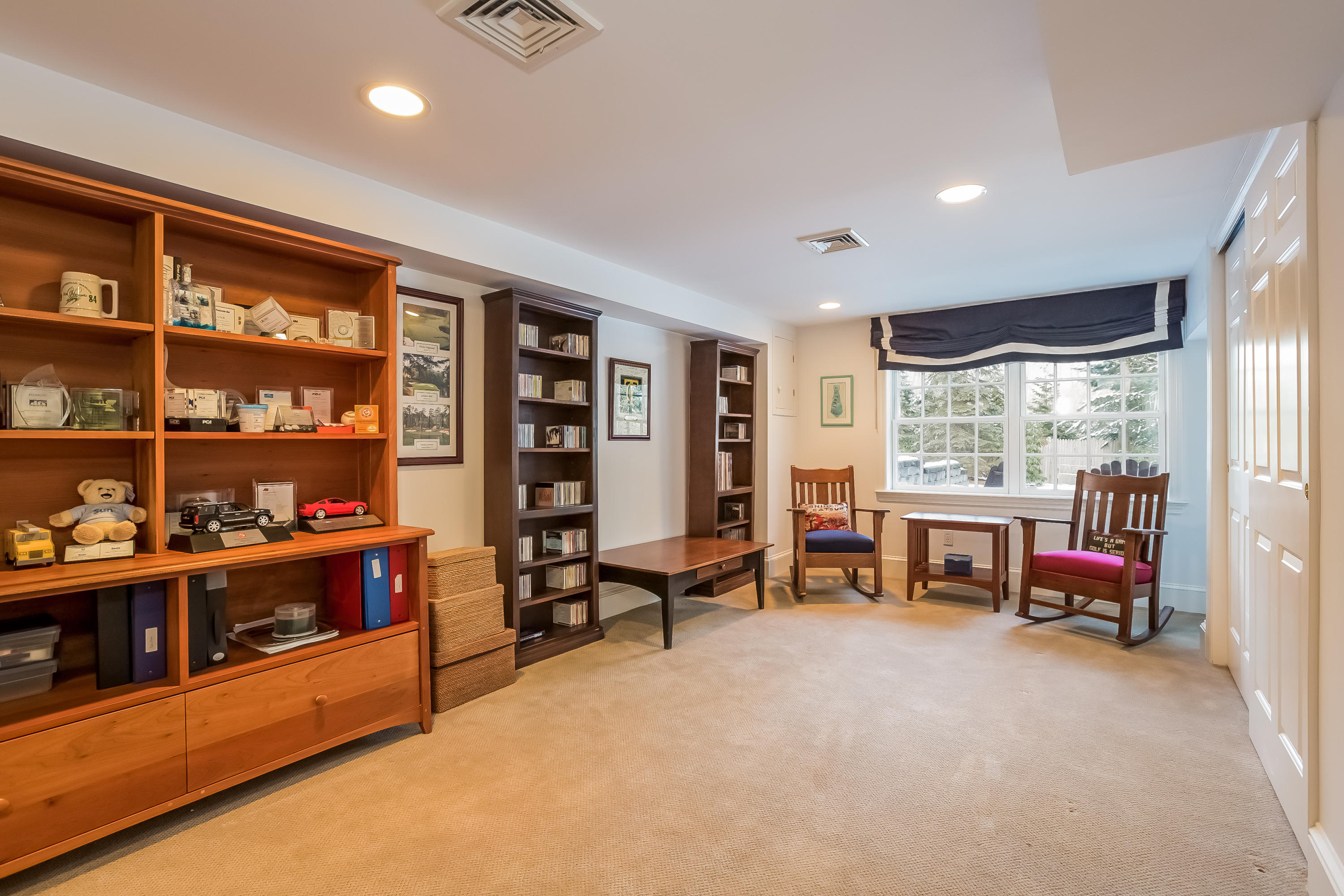 6 Watch Tower Road Darien, CT 06820 - Photo 20 of 30 a living room with furniture a bookshelf and a large window