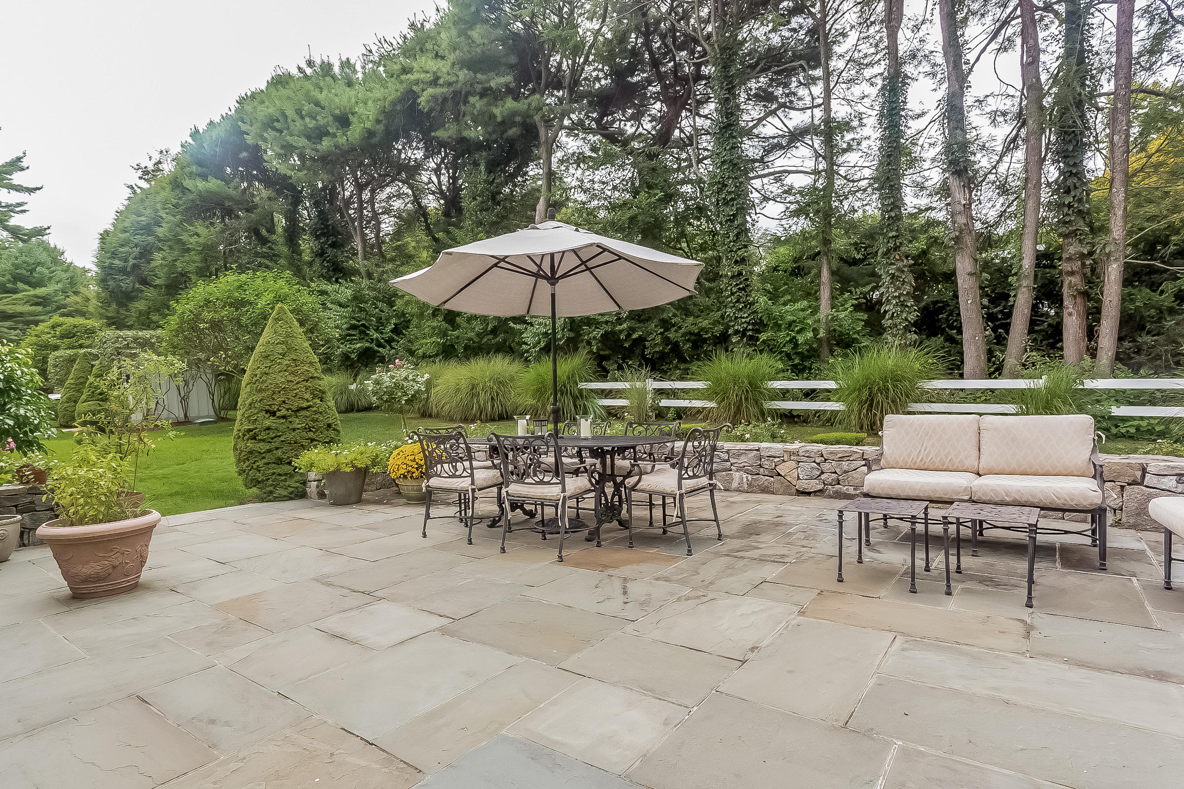 6 Watch Tower Road Darien, CT 06820 - Photo 26 of 30 an outdoor space with patio and white umbrellas