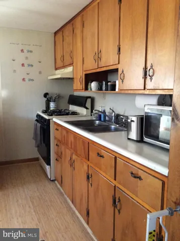 a view of an empty room with window and a livingroom