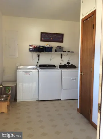 a large bed sitting in a bedroom next to a window