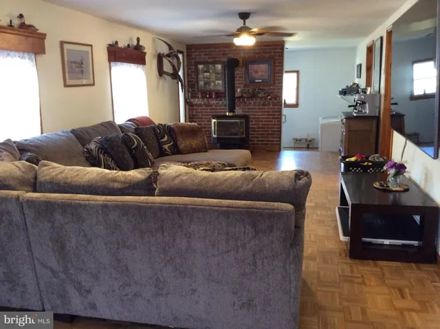 a living room with furniture and a fireplace