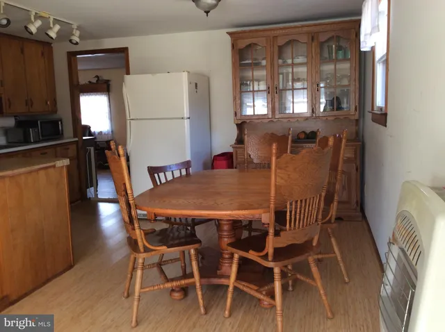 a kitchen with stainless steel appliances a stove a sink and white cabinets