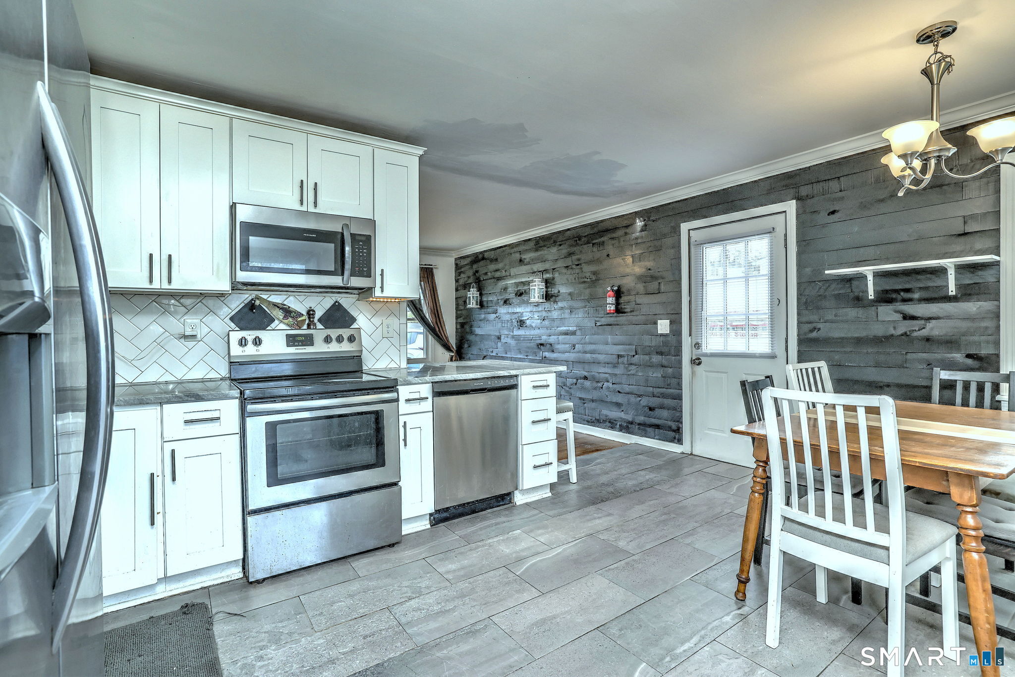 42 Highland Avenue Ansonia, CT 06401 - Photo 16 of 40 a kitchen with a stove a sink and a refrigerator
