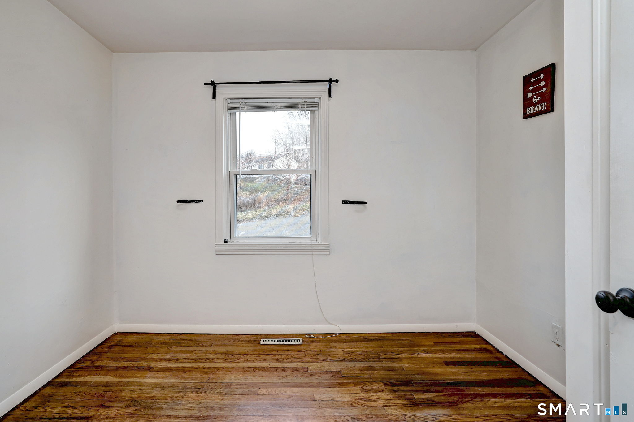 42 Highland Avenue Ansonia, CT 06401 - Photo 19 of 40 a view of an empty room with wooden floor and a window