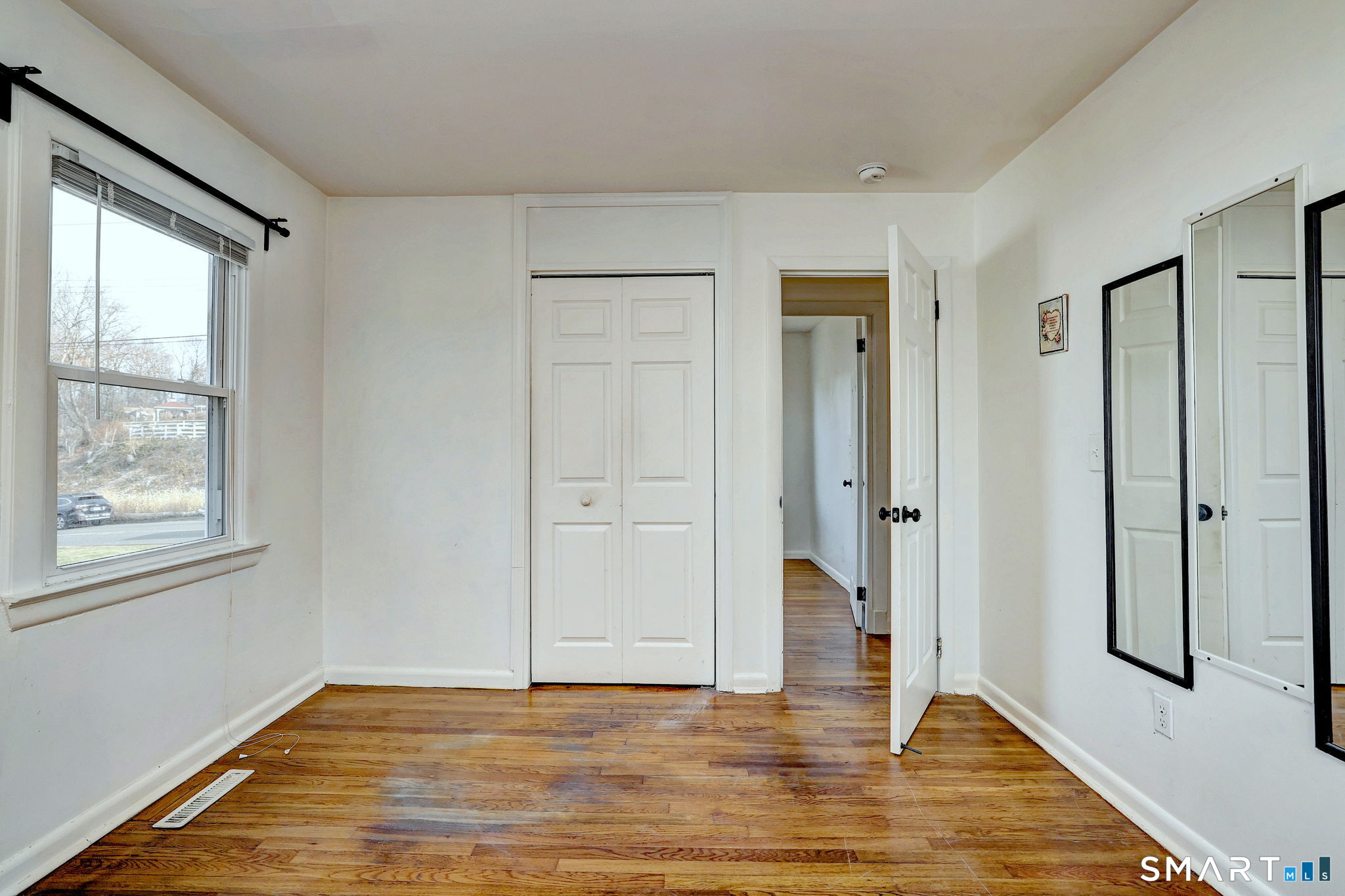 42 Highland Avenue Ansonia, CT 06401 - Photo 25 of 40 a view of an empty room with window and wooden floor