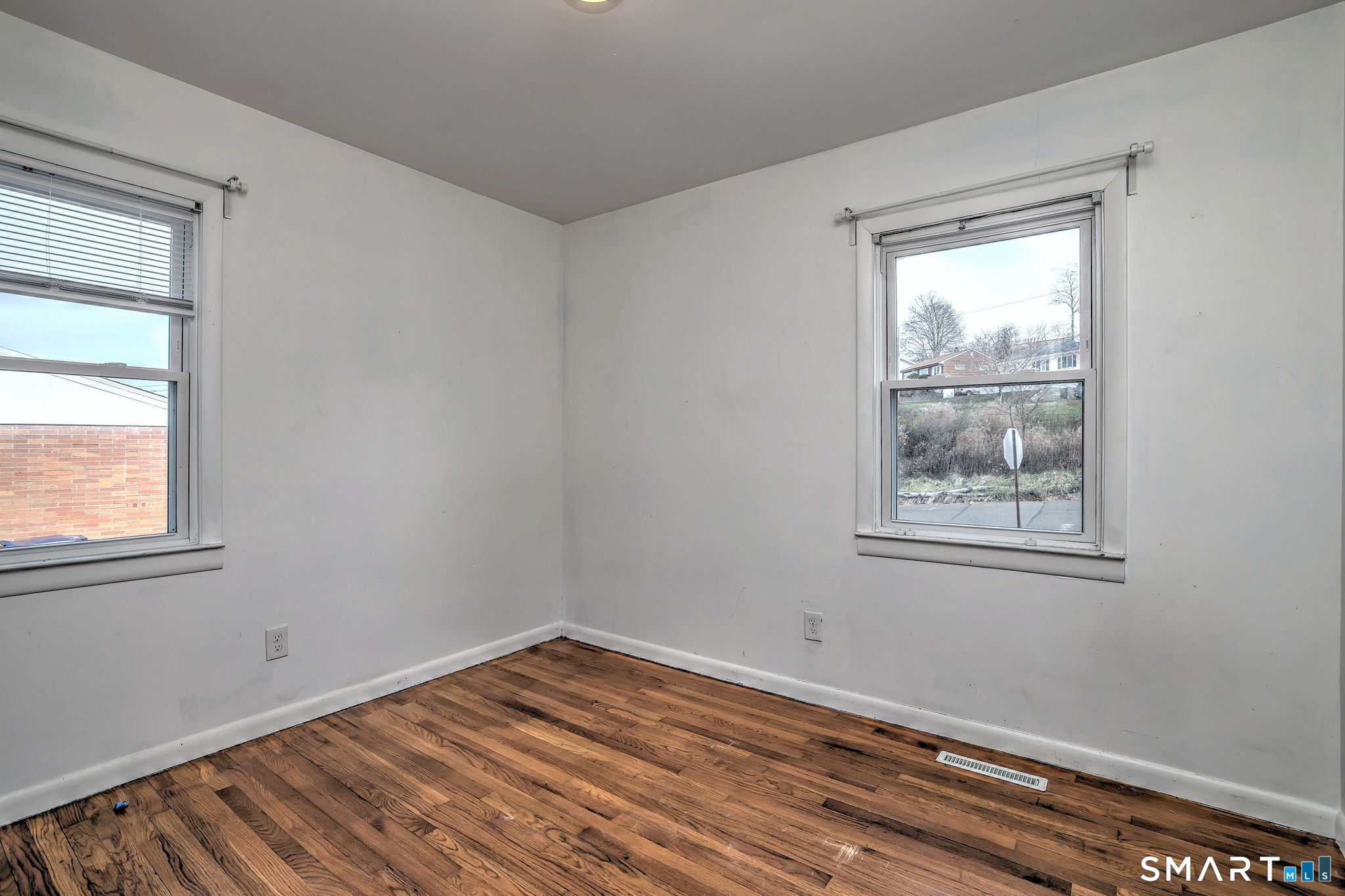 42 Highland Avenue Ansonia, CT 06401 - Photo 27 of 40 a view of an empty room with wooden floor and a window