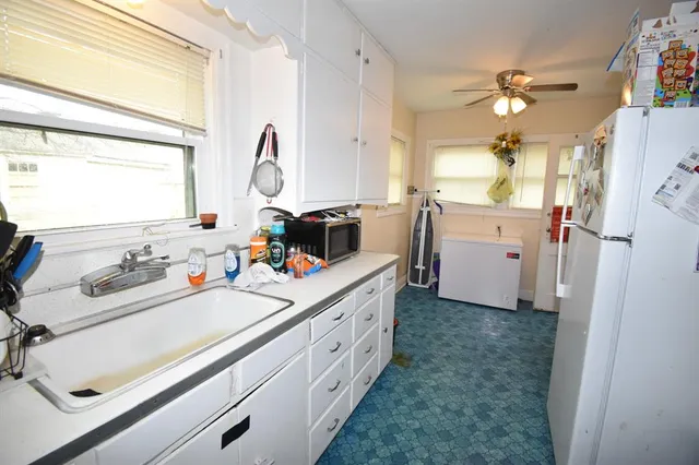 a kitchen with a sink appliances and a window