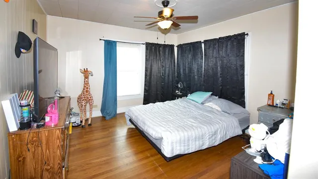 a bedroom with a bed and a chandelier