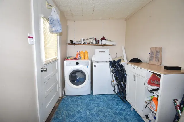 a utility room with sink dryer and washer