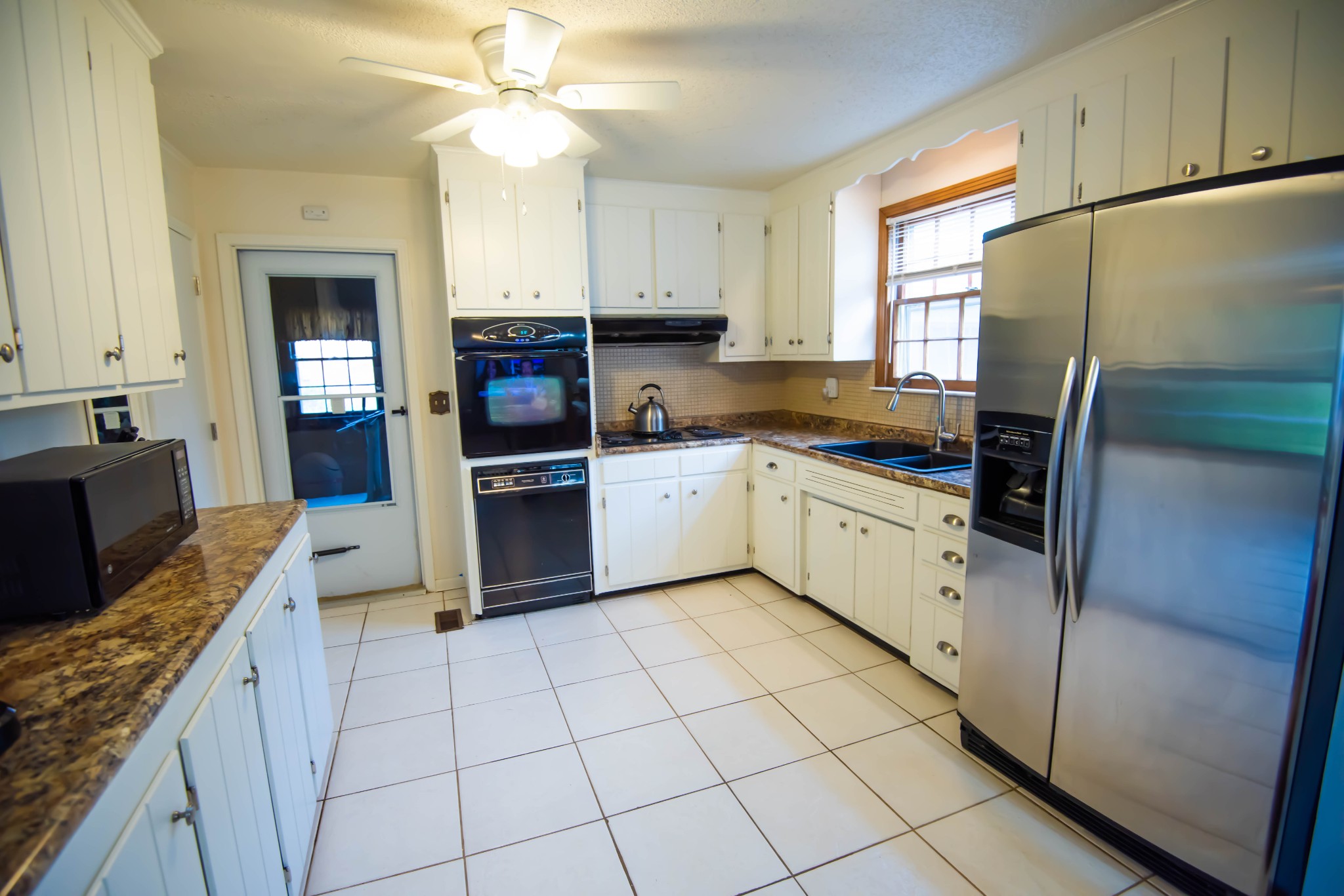 205 Green Harbor Road Old Hickory, TN 37138 - Photo 30 of 36 a kitchen with stainless steel appliances a refrigerator sink and cabinets