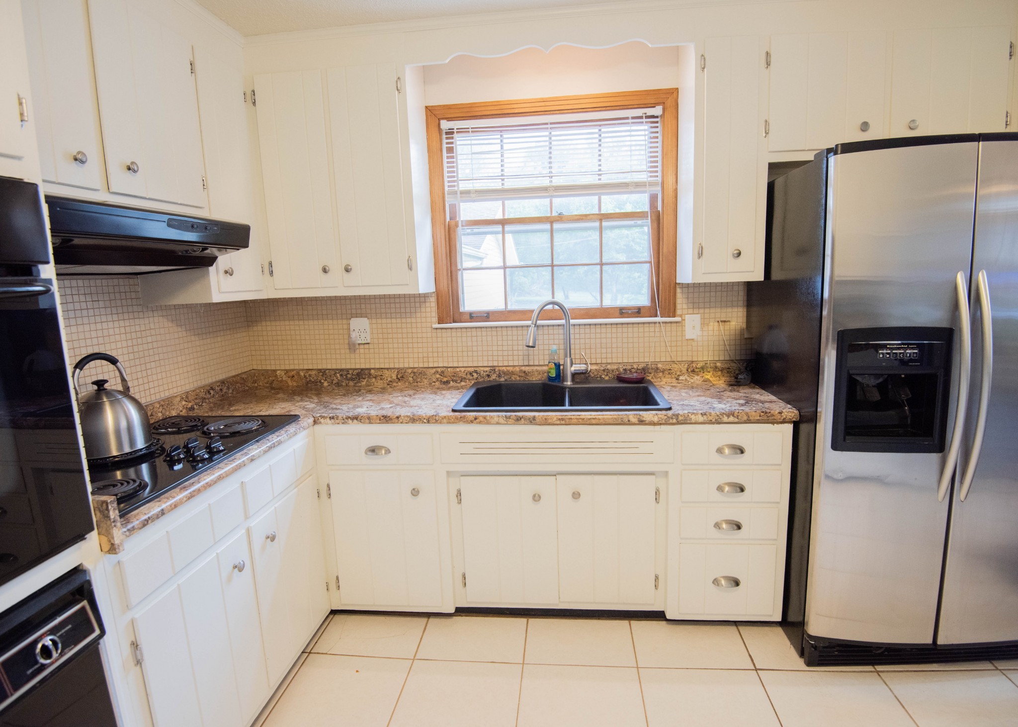 205 Green Harbor Road Old Hickory, TN 37138 - Photo 32 of 36 a kitchen with granite countertop white cabinets white stainless steel appliances a sink and a window