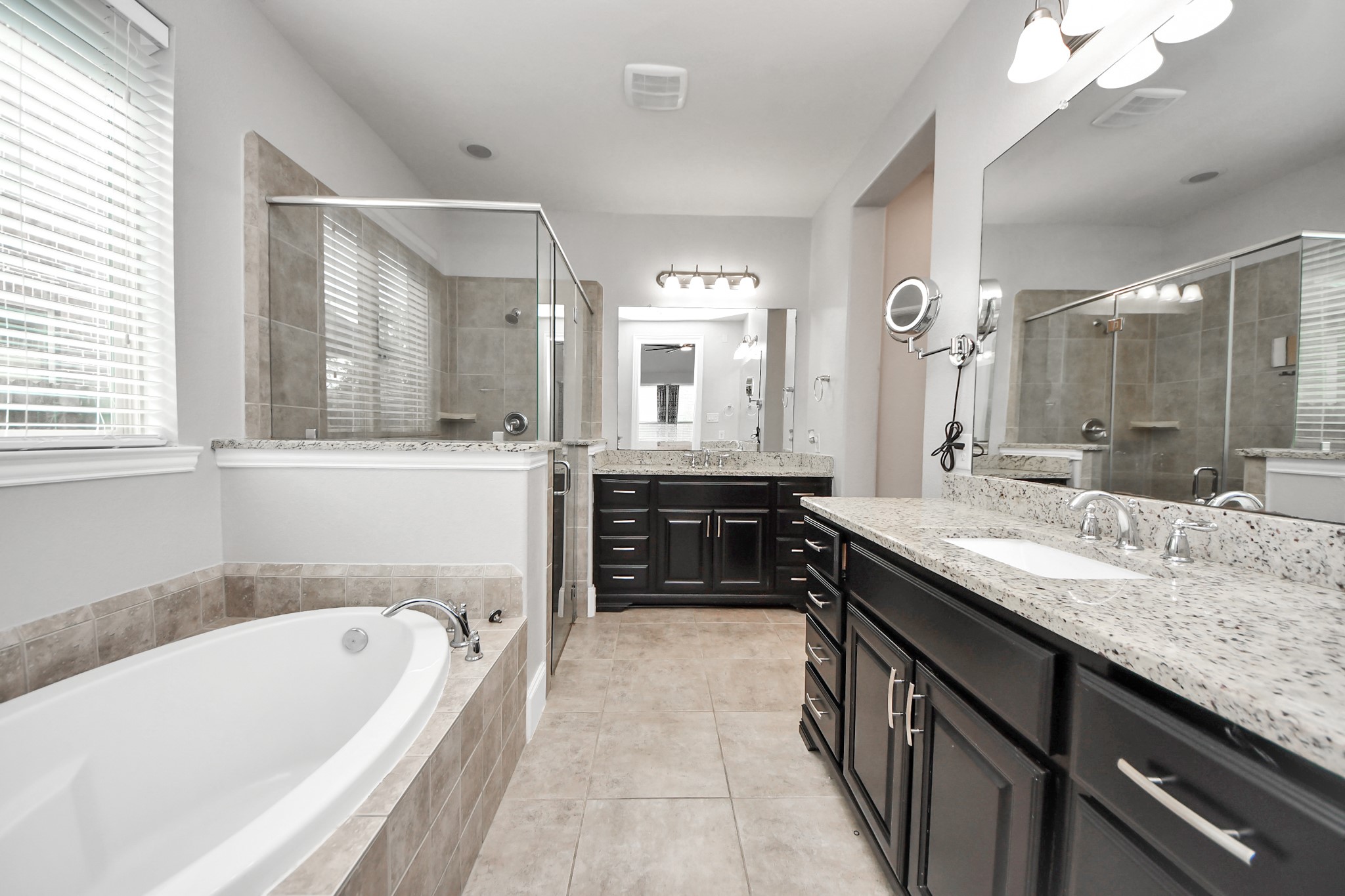 4811 Applewood Crest Lane Rosharon, TX 77583 - Photo 19 of 45 a spacious bathroom with a granite countertop tub double vanity and a mirror