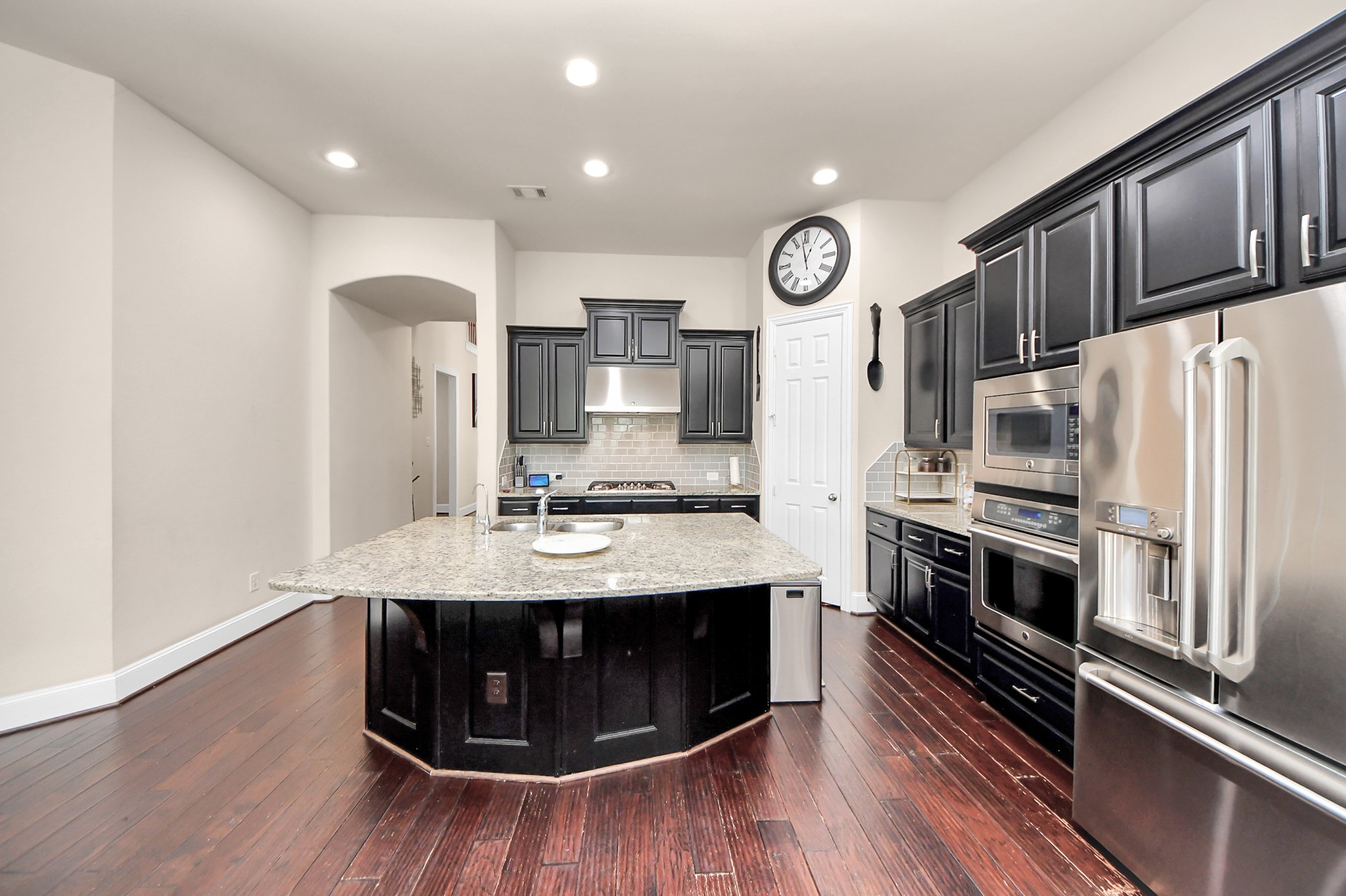4811 Applewood Crest Lane Rosharon, TX 77583 - Photo 8 of 45 a kitchen with stainless steel appliances granite countertop a sink a stove a refrigerator cabinets and a wooden floor