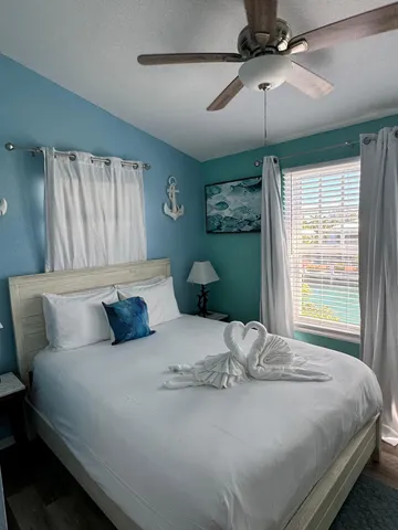 a bedroom with a bed and a window