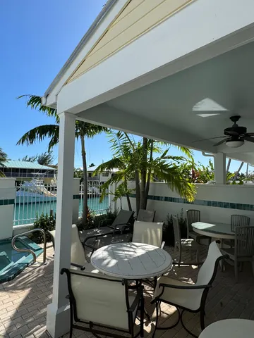 a view of a patio with table and chairs and potted plants