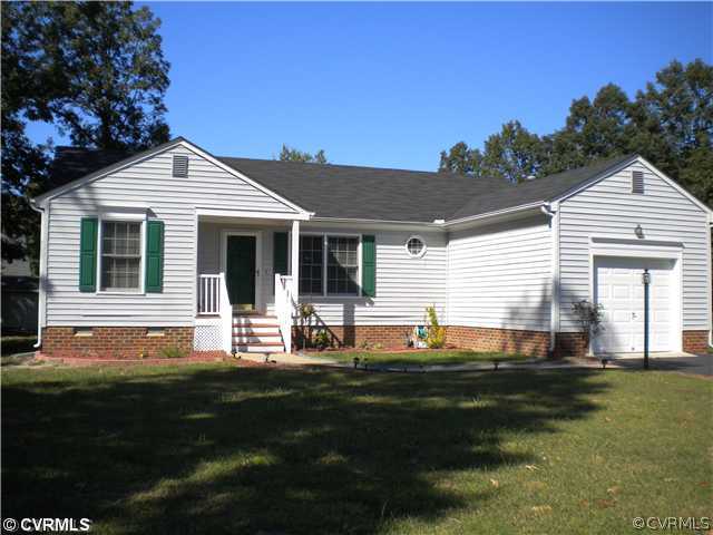 7376 Trailing Rock Road Prince George, VA 23875 - Photo 1 of 9 a front view of a house with a garden and patio