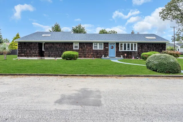 a front view of a house with a garden and deck