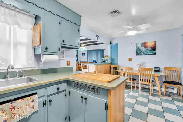 a kitchen with stainless steel appliances kitchen island granite countertop a sink and a cabinets