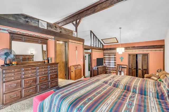 a bedroom with a bed a dresser and large mirror