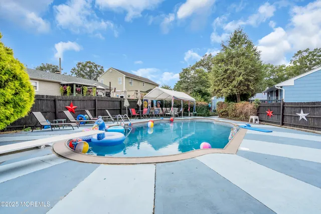 a view of a swimming pool with a yard