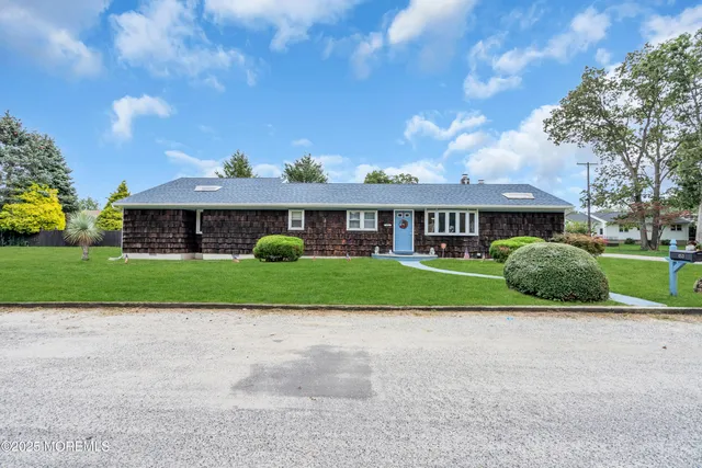 a front view of house with yard and green space